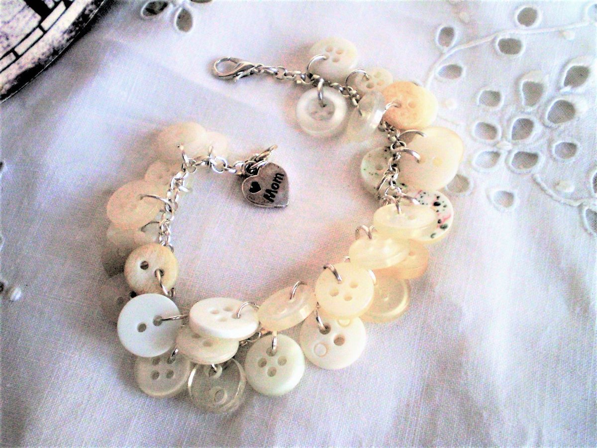 Joannetcetera's tweet photo. Excited to share a favourite from my #etsy shop: Repurposed Button Cha Cha Bracelet with XOXO Love Mom Charm - upcycled, Mother&amp;#39;s Day, ivory buttons, gift for sewer, quilter, budget #jewelry #bracelet #repurposedbuttons #buttonjewellery https://t.co/TqHuVMn4ja https://t.co/DBEMRxh4fy
