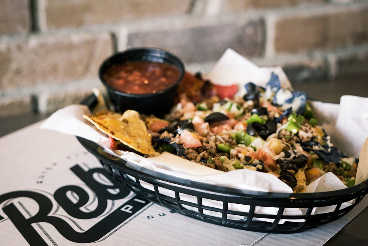 Introducing our brand new Rebel Nachos! Nachos, cheese, choose up to 4 veggies, taco beef and drizzled with warm jalapeño cheese sauce plus salsa and sour cream on the side. Only $10.99! Available Sunday and Monday, dine in only.