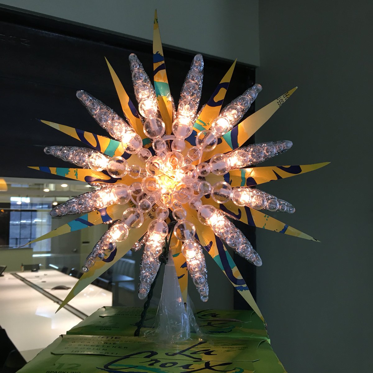 carmichaellynch's tweet photo. Decorating the office in homage to @lacroixwater - the undisputed hero of the office. We call it...LaChristmas Tree™️ https://t.co/LdUQ48If9o