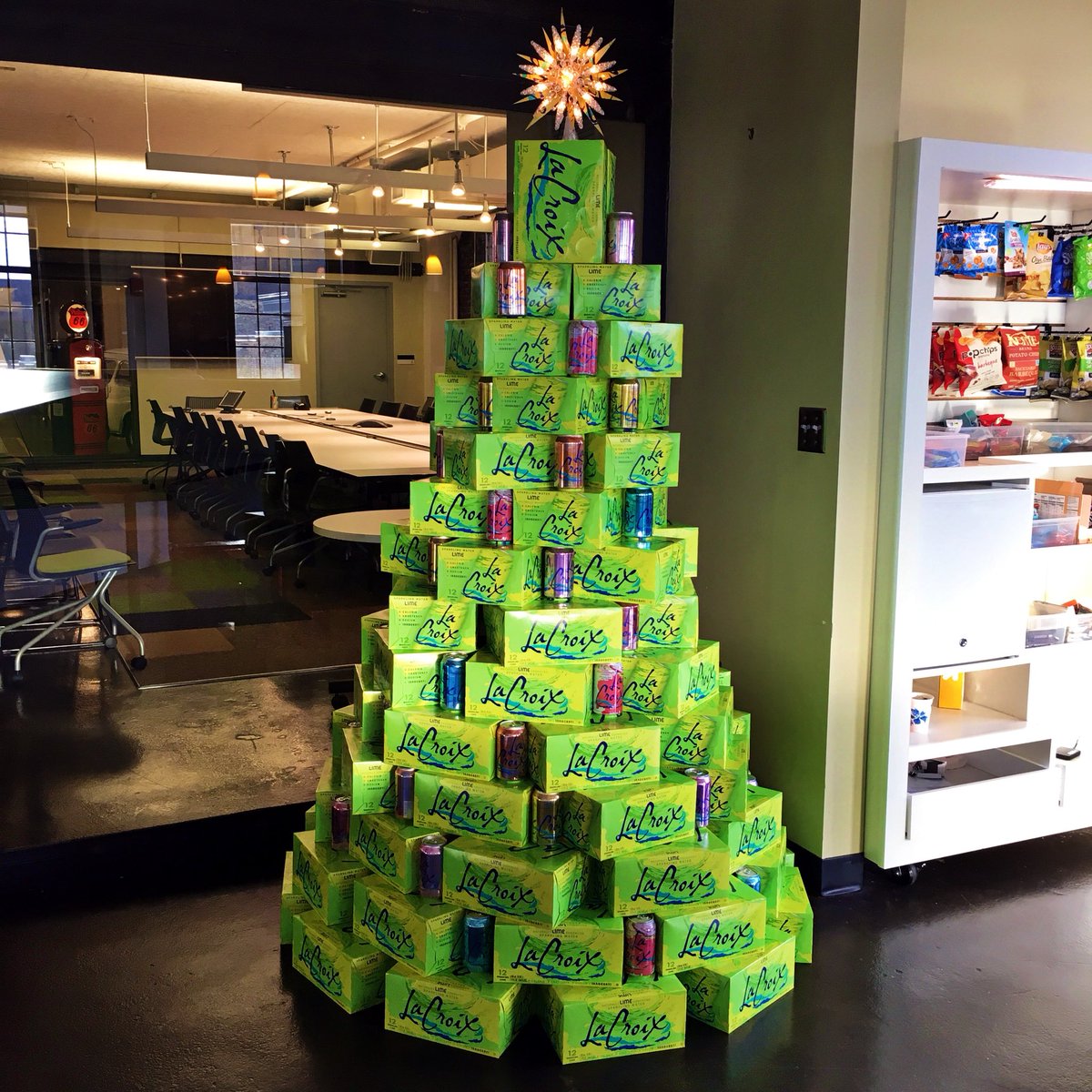 carmichaellynch's tweet photo. Decorating the office in homage to @lacroixwater - the undisputed hero of the office. We call it...LaChristmas Tree™️ https://t.co/LdUQ48If9o