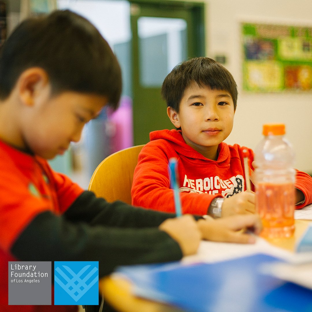 photo of two children studying