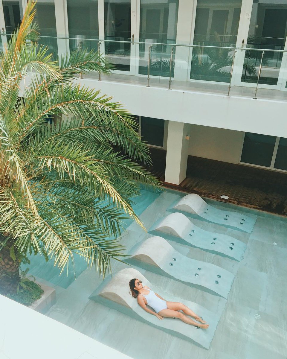 AstoriaCurrent's tweet photo. It looks like @clauivillanueva found the perfect spot for the right amount of sun - on our half-sunken aqua seats! ☀ https://t.co/5nMQgq4WQM
