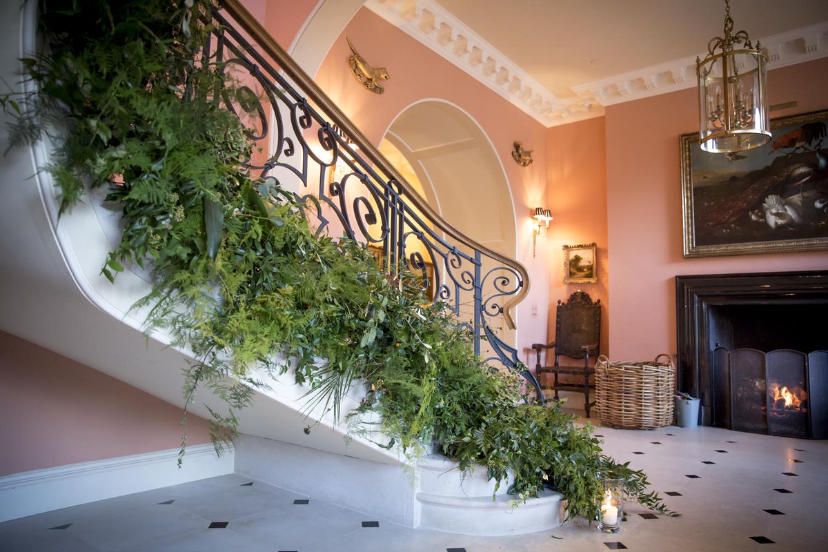 RockleyManor's tweet photo. A roaring fire provides a warm welcome in the hall. Chrissie Wiltshire Flowers decorated the staircase beautifully with seasonal flowers and lanterns for our bridal weekend. #exclusiveuse #flexibleweddings #weddingvenue #countryhouseweddings Photo: Adrian Travis Photography https://t.co/uQQF2jF2U3