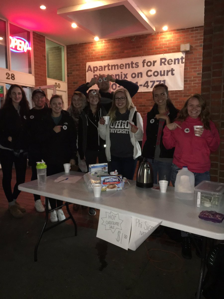 OUPassionWorks's tweet photo. Students from Phi Sigma Pi wearing their Flower Day stickers as they sell hot chocolate tonight! Looking good, y'all! #PowerOfTheFlower https://t.co/jP2H7BuzY4