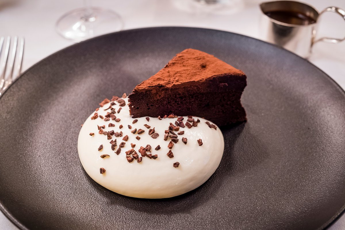 Pop-in for our Flourless cappuccino cake. Warm chocolate cake, milk mousse and coffee sauce. #IvyCafeWimbledon