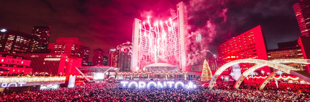 Photograph of fireworks above a massive crowd at last year's celebration held at Nathan Phillips Square