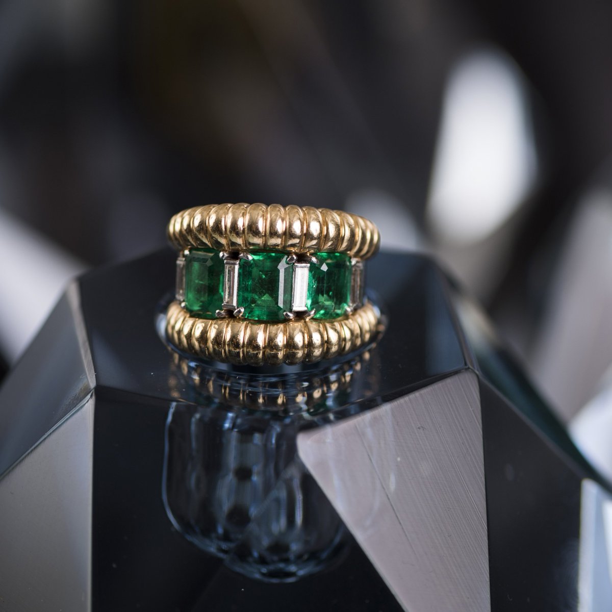 A dazzling holiday awaits with exceptional one-of-a-kind gifts from Fred Leighton. 1940s gold, emerald and diamond ring by Boucheron. #vintagejewelry #FredLeighton