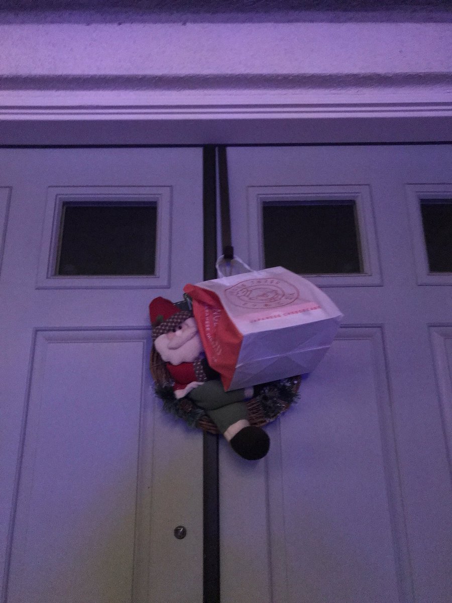erinthhuang's tweet photo. We weren’t home so my mom’s friend hung a present (cake) on our wreath hook...  she said she didn’t want the squirrels to get it 😂 https://t.co/gyJF0rwtMG