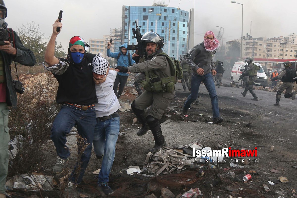 AbbsWinston's tweet photo. #Israeli Occupiers disguised in civilian clothing, #Palestinian flag and kufiya’s pretending to be Palestinian protestors in a crowd, pull out their guns and kidnap 5 youths in Al-Bireh City. https://t.co/kvRfLY8uF6