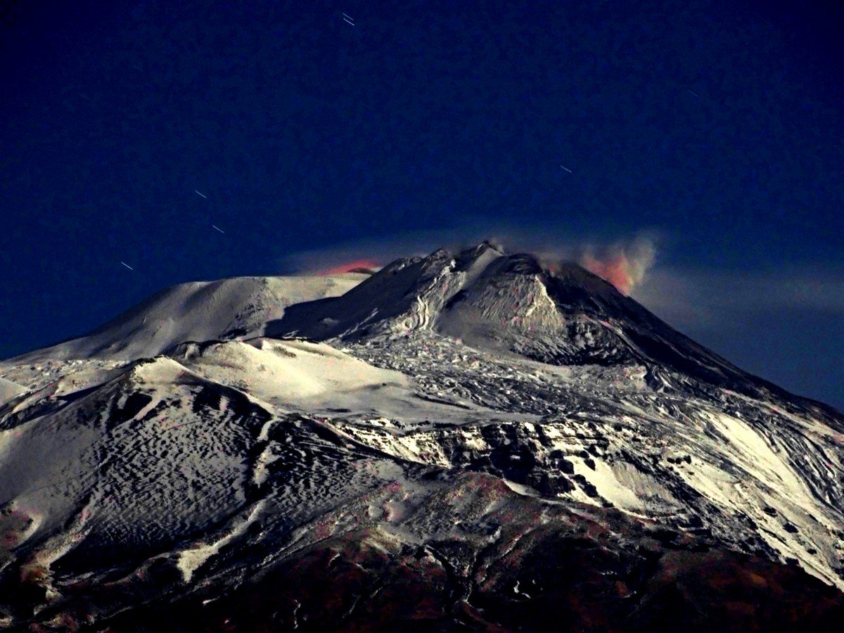 Etna is being beautiful under the full moon, with two vents ("u puttusiddu", of the New Southeast Crater, at right, and "nautru puttusiddu, of the Voragine crater, at left) showing incandescence, caused by high-temperature gas emission. Seen from home, 3 December 2017