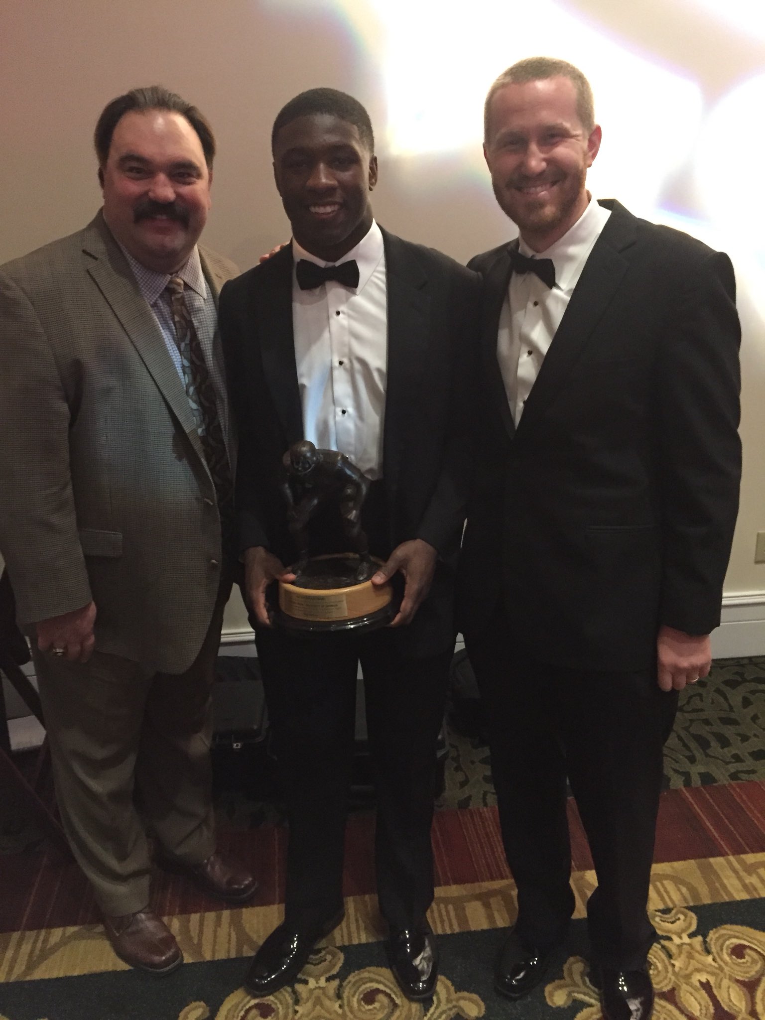 Georgia linebacker's coach Glenn Schumann (right) poses with Bulldog junior ILB Roquan Smith (middle) after being named and presented the 2017 Butkus Award at the annual UGA football Gala in Athens. (Photo from Glenn Schumann / Twitter)