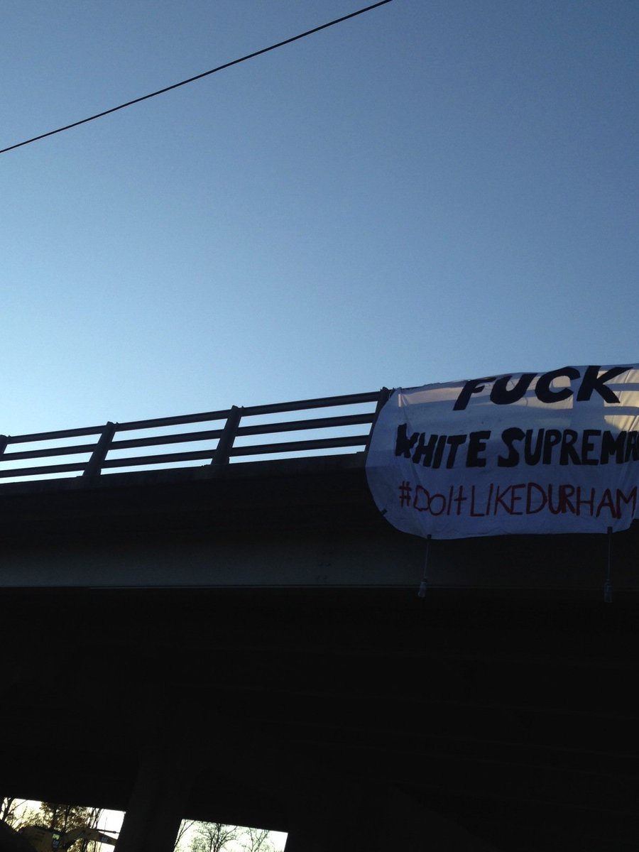 nc_autonomy's tweet photo. Drop the Charges! Banner drop seen on 147. #DefendDurham #DoitLikeDurham #AntiFascistMeansAntiState #FuckYoStatue https://t.co/RbXVScNBog