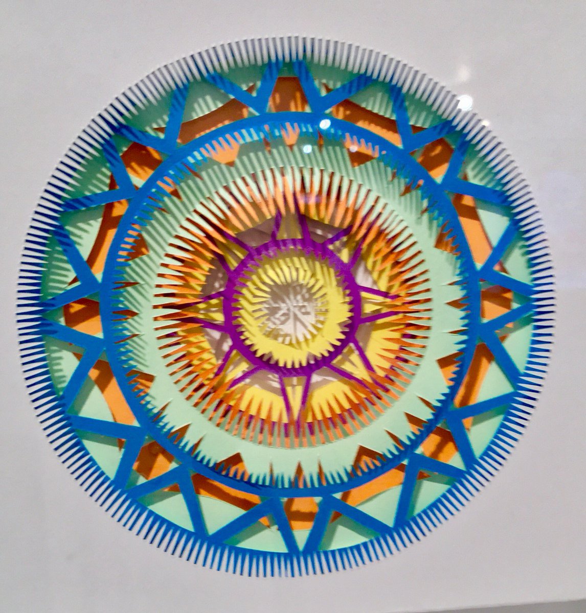 make_southwest's tweet photo. kaleidoscopic paper swirls in slo mo- Clare Pentlow's colourful, framed handcut #paper #art now on show @devonguild in #make2017 #christmasgiftideas https://t.co/KTfZjBMhvV