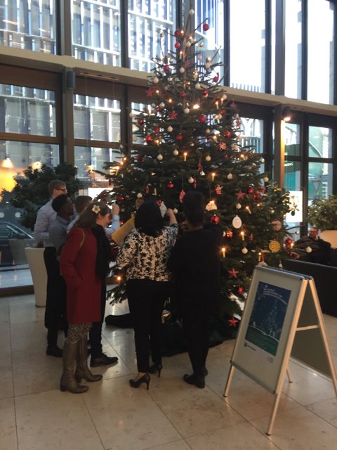 GrossHarrisonJL's tweet photo. Colleagues in the foyer at BNP Paribas @BNPP2S in Europa-Allee Frankfurt taking Christmas gift wish cards from classes at a school for children with learning challenges. They then purchase a present which will be for the good of the class. Corporate Social Responsibility https://t.co/GRVNiGCVaC