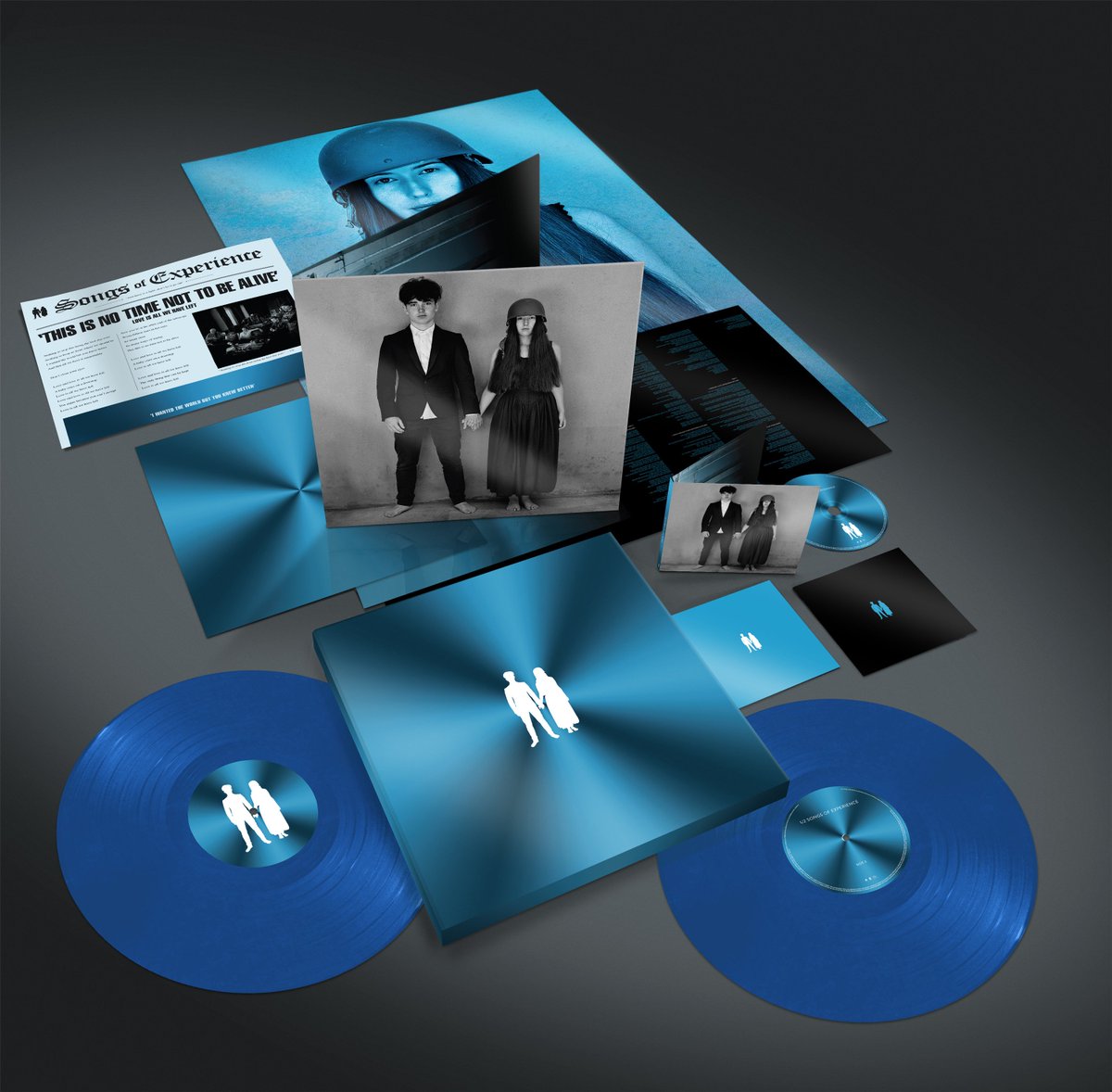 U2's tweet photo. 'This is no time not to be alive…’  Seen the deluxe Vinyl &amp; CD formats of Songs of Experience? They’re beautiful in blue. 
#U2SongsofExperience #U2 https://t.co/XhGU0nJ5zL https://t.co/IHS0KO76CU