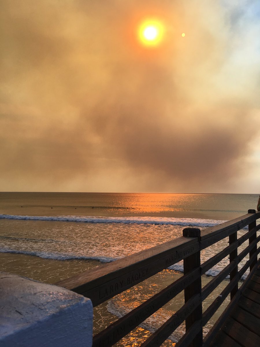 illuminancy's tweet image. Smokey surfs up. Waves south side of Oceanside pier. Smoke from #lilacfire #CaliforniaWildfires