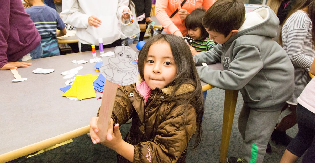 girl with Wonder Woman on a stick