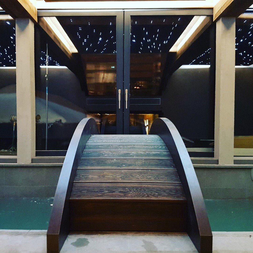 BoutiqueChalet's tweet photo. Swimming under the stars in the indoor-outdoor swimming pool that runs the length of the chalet. #ChaletJouxPlane, #Morzine  #luxurychalet https://t.co/TE6M8qa2mp