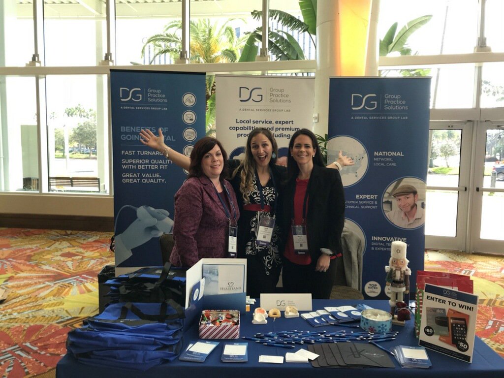 Team DSG: Jenn Lalli, Jenny Holla, Alyse Latham and Tom Cacavas, manning brand new booth feat. new signage &amp; collateral ready to share w/ attendees of Heartland Dental Winter Conference @ Orlando. Looking forward to networking and sharing DSG expertise with new friends! #teamdsg