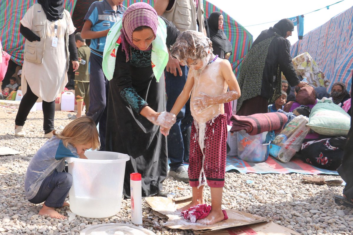 Medair_ME's tweet photo. When the walk to safety has been long and dusty, some soap and water feels so good! We were positioned at the perimeter of conflict areas near #Hawiga, providing mobile health clinics, fresh water and emergency sanitation, and distribution of hygiene kits. #whatwedidin2017 #Iraq https://t.co/l3Mi4k7zpk