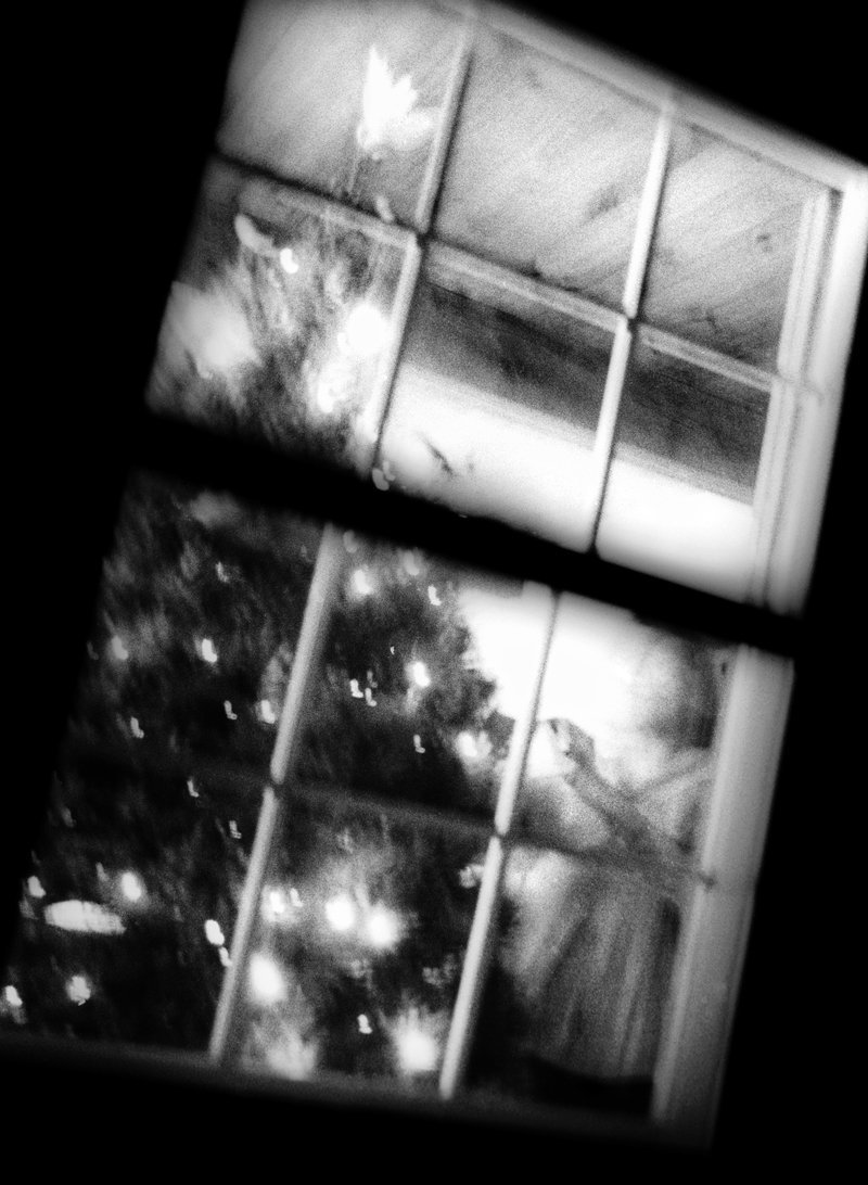 Mom decorating the Christmas tree at night, many years ago. See the dove atop the tree? The same one is there this morning. Merry Christmas!