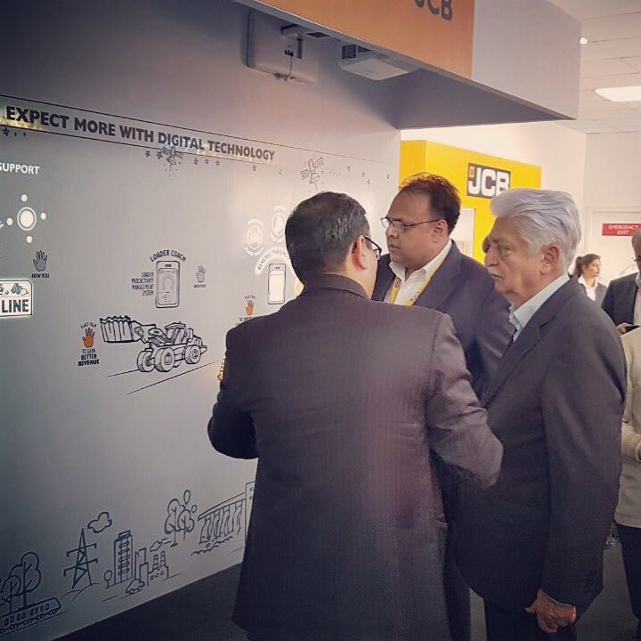 Viscomm_'s tweet photo. We’re so excited that Mr. Azim Premji is experiencing the Touch Wall we designed for JCB at EXCON 2017! #EXCON2K17 #TheFutureIsIntelligent https://t.co/pHxWXq8ENB