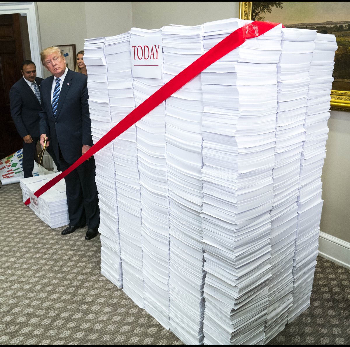 dougmillsnyt's tweet image. .@realDonaldTrump stands next to a stack of papers after announcing “We will get rid of the redundancy and duplication that wastes your time and your money.” #regulations