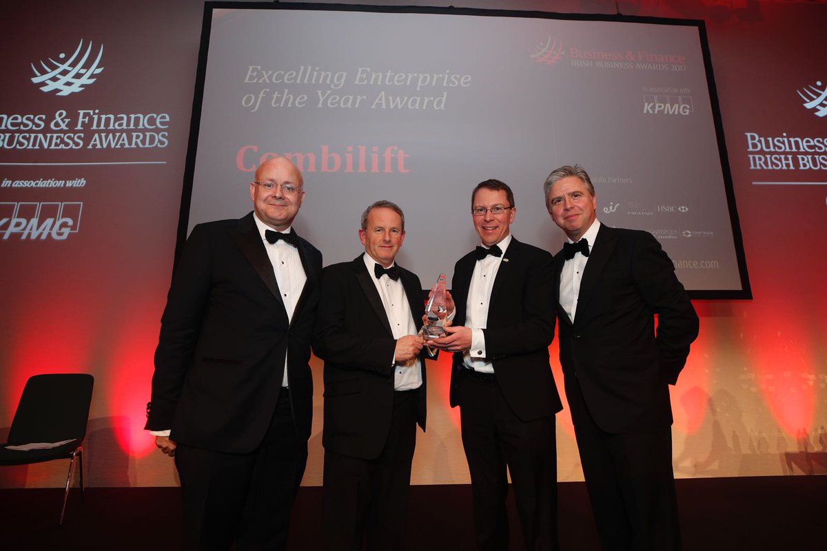 Combilift's tweet photo. Our founders Robert Moffatt and Martin McVicar accepting the Excelling Enterprise Award  #bandfawards from Shaun Murphy of @KPMG_Ireland &amp; @Ian_Hyland @BandF @Entirl https://t.co/pUFNRTOhjq