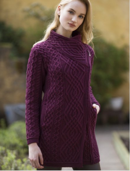 This beautiful cable knit double-breasted coat features the diamond trellis stitch along the centre of the coat and the side zip along the left hand side of the garment. Also, features insert pockets. bit.ly/2CoZl3o