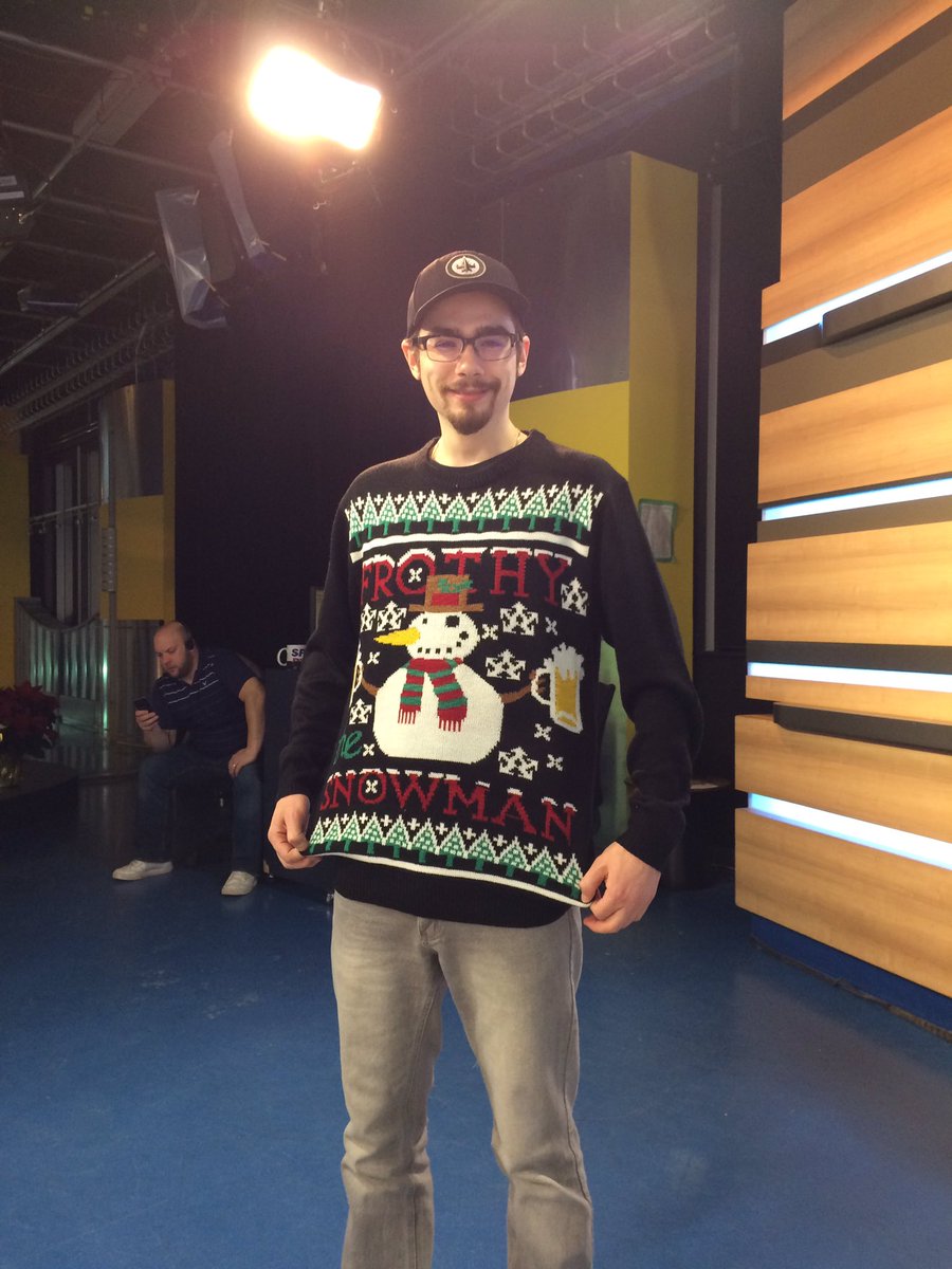 NicoleDubeMedia's tweet photo. It's national #uglychristmassweaterday and studio crew member Jesse is honouring the day in fine attire! #FrothyTheSnowMan 😆👏🏻 https://t.co/2WBySG3dDl