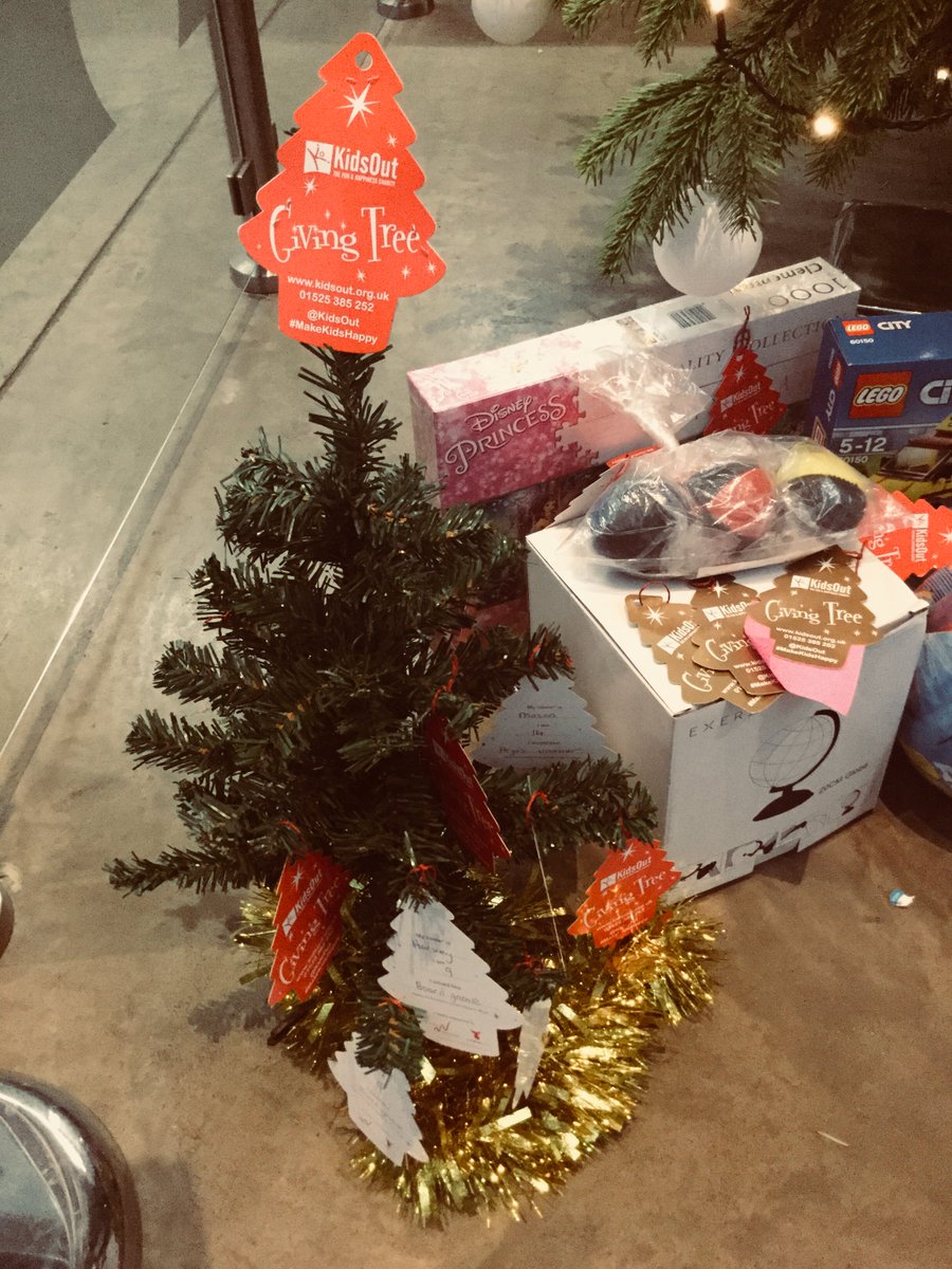 RavensbourneUK's tweet photo. The tree beneath the tree... 🎄Thanks to all who have donated so generously to @KidsOut's #GivingTree2017, asking you to purchase an extra present for a child in refuge if you are able. Gifts will be shipped Monday! 🎁 https://t.co/C5EybPwszo