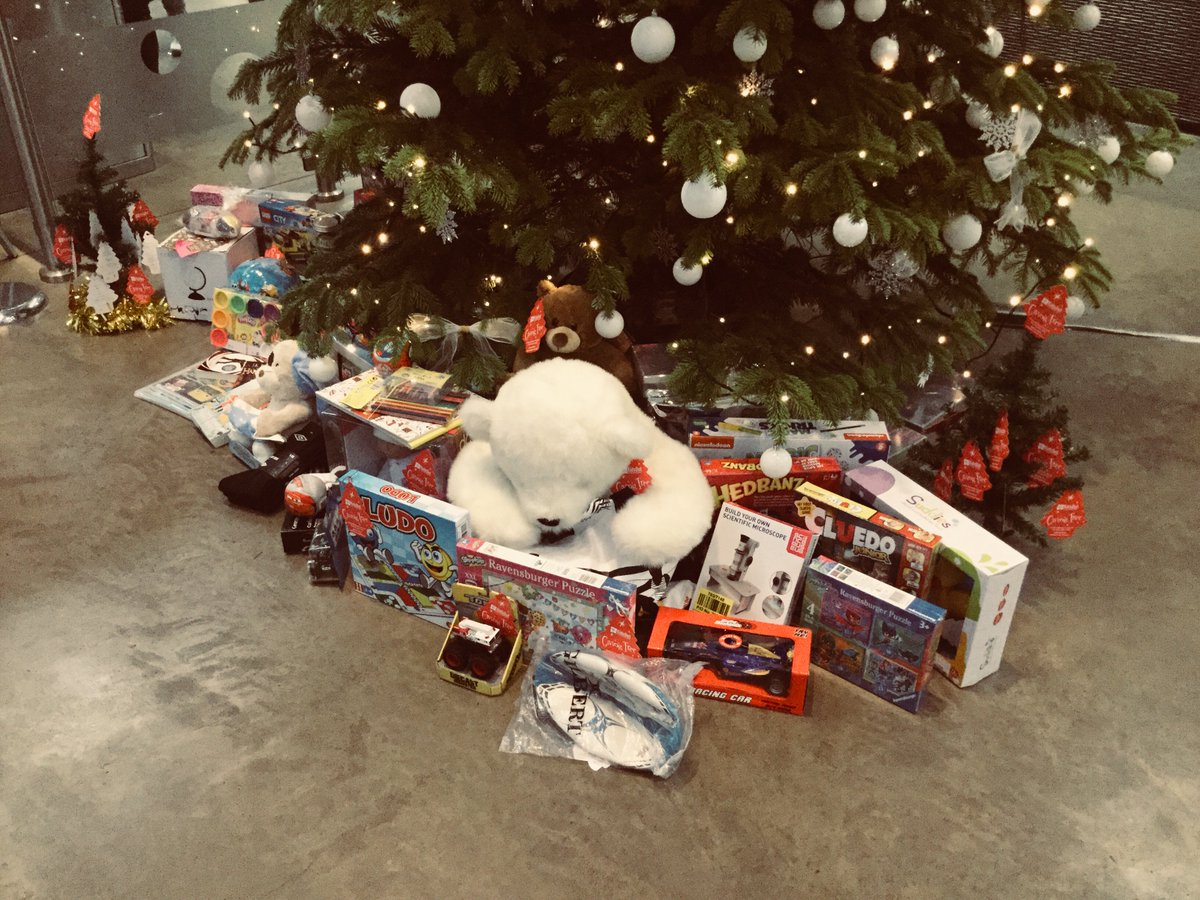 RavensbourneUK's tweet photo. The tree beneath the tree... 🎄Thanks to all who have donated so generously to @KidsOut's #GivingTree2017, asking you to purchase an extra present for a child in refuge if you are able. Gifts will be shipped Monday! 🎁 https://t.co/C5EybPwszo