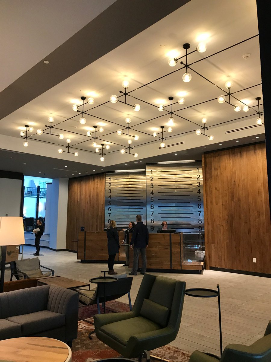 HiltonWoburnBOS's tweet photo. #design is in the details! Our check-in pays homage to Woburn’s shoemaking legacy with displayed artifacts and a wall inspired by a shoe size measuring device. Anyone know what that device is called? #trivia https://t.co/G9vze00yOq