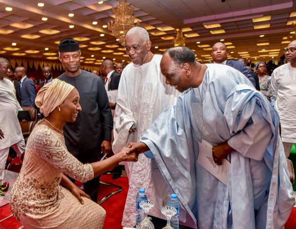 GOWON: Ah... Stand up Dolapo.. A whole wife of the VP
DOLLY: I am a Yoruba woman sir, Being VP's wife won't change that sir. 
PROF: See my baby.. Home training flowing like milk &amp; honey
