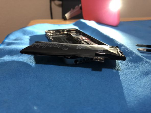 iFixit's tweet photo. What's worse than finding a lump of coal in your stocking? Finding a battery in your iPhone that looks like a lump of coal. https://t.co/q4AMR8KpjB https://t.co/Ilbh1yW9bH