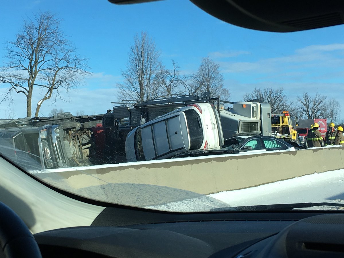 APreciousProd's tweet photo. Wow crazy accident at the #401 the cop car is literally squished https://t.co/HfkdDPr6HB