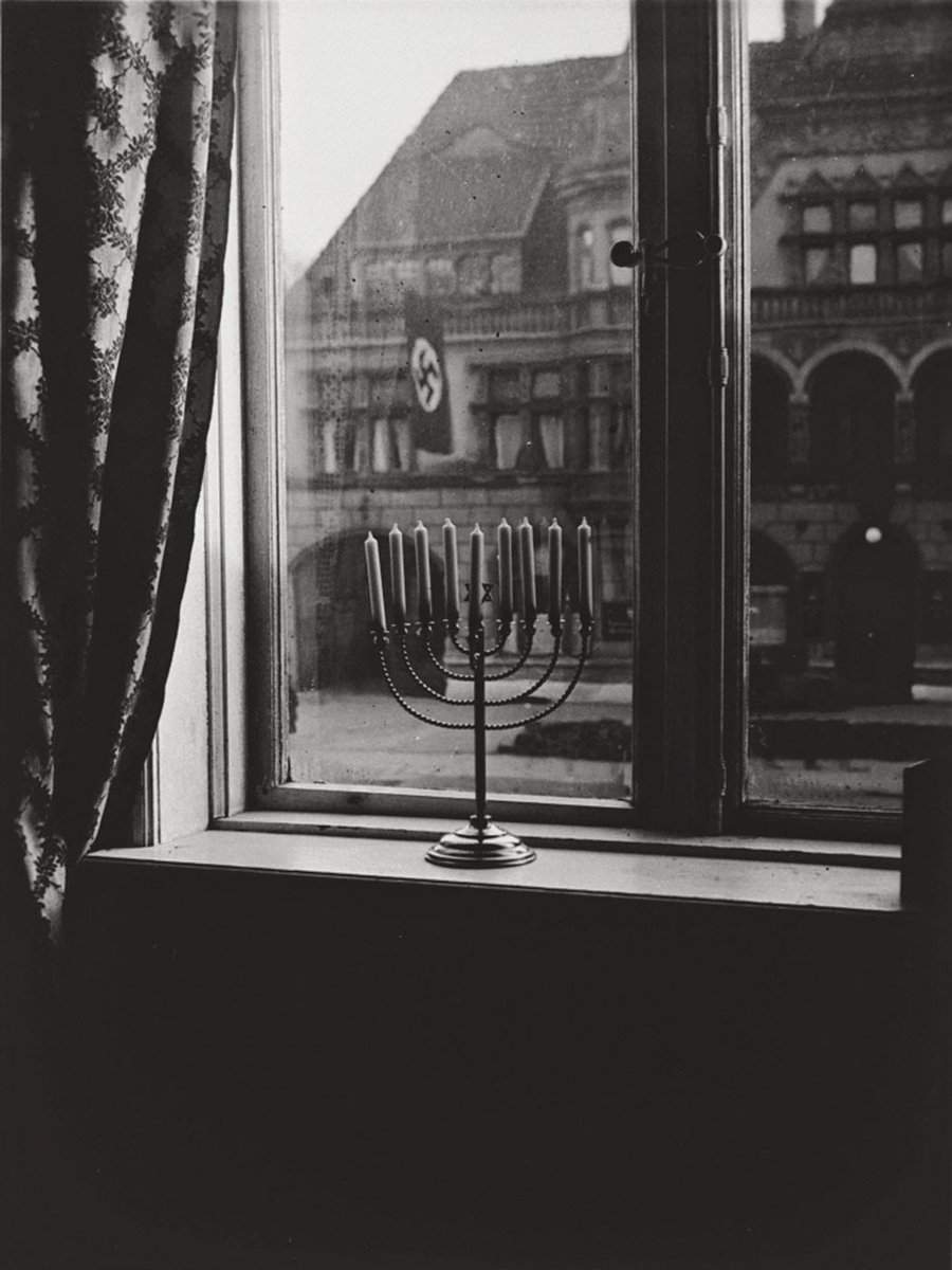 This is what #Resistance looks like. Hanukkah in Germany, 1931. On the back of the photo was written, "Our light will outlast their flag."