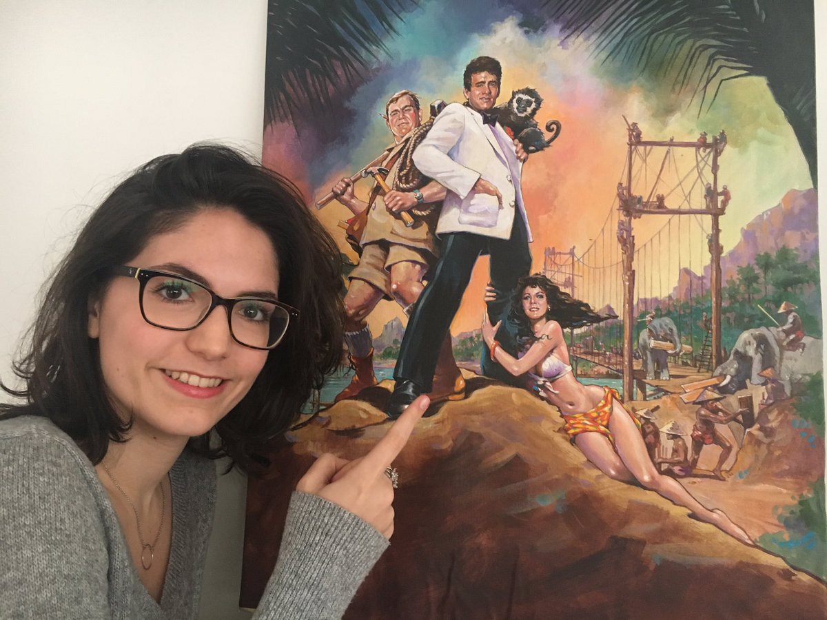 GIRODPATRICE's tweet photo. @CarlaGirod looking at the original alternate painting of #NicholasMeyer's Volunteers movie poster. Quite an important movie in the life of @tomhanks and @RitaWilson ๐ seen here in a very #pincessleia position alongside the great and late #JohnCandy https://t.co/uieKVUas18