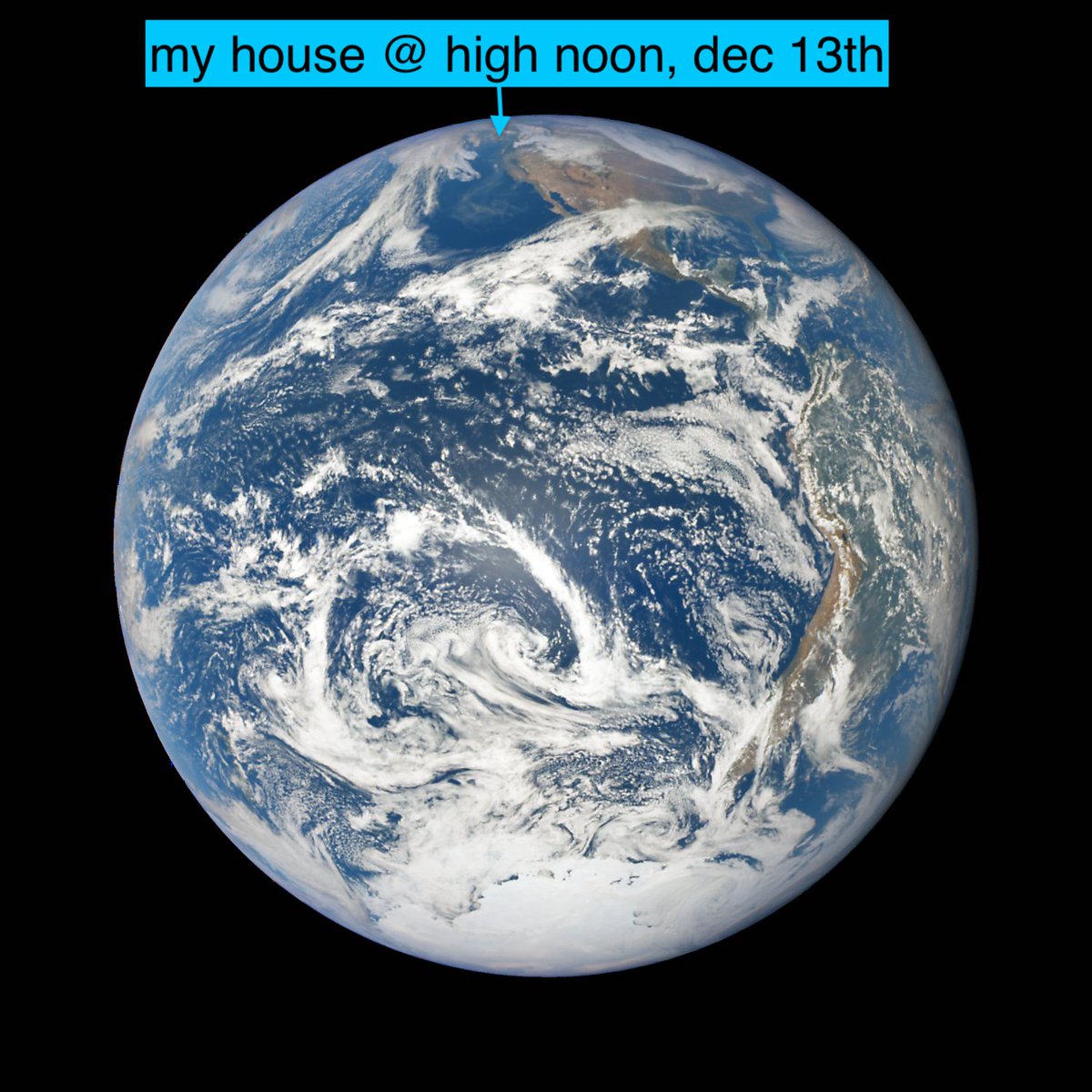 A satellite photo of the earth taken at around noon Pacific, with the author's house indicated at almost the very tippy top of the sphere