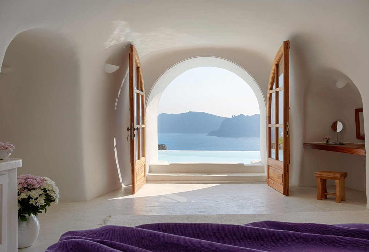 PerivolasHotel's tweet photo. "The sea had no surface; only the hills opposite didn't end at the earth's rim, but advanced beyond [...] There was a sense that another side of life exists." - G. Seferis ✨Warm wishes for a lovely holiday season and a happy #NewYear!✨ #perivolas #santorini photo: @WAbranowicz https://t.co/5GqEBfy1QZ