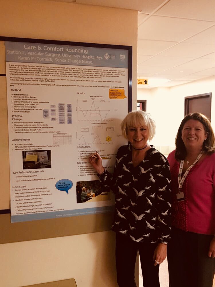 QI in Action board at University Hospital Ayr situated outside lecture theatre. <a href="/Karen_EMcC/">Karen McCormick</a> discussing her QI project with <a href="/shazbag1/">shazbag</a>