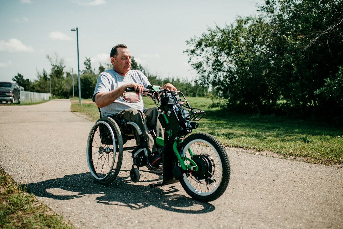 NeilSquireSoc's tweet photo. Patrick has been volunteering for @SCI_BC's Access North project. He found it tiring to push his manual wheelchair along trails for accessibility audits.
Through #BCTechAtWork funding, he received a power assist. “I can go for hours in the outdoors.” https://t.co/JvWBiJLdcu https://t.co/dHMpoayNZf