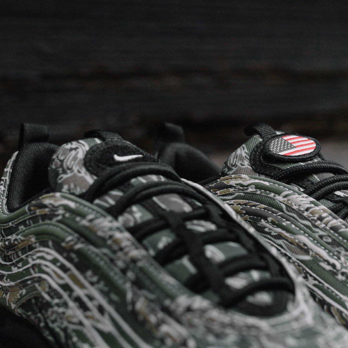 Notre's tweet photo. Nike Air Max 97 Camo. Featuring a camo pattern inspired by the armed services and a removable U.S.A. flag patch on the tongue. Releasing in-store and online Thursday 12/21 https://t.co/PbqrqU9GPm