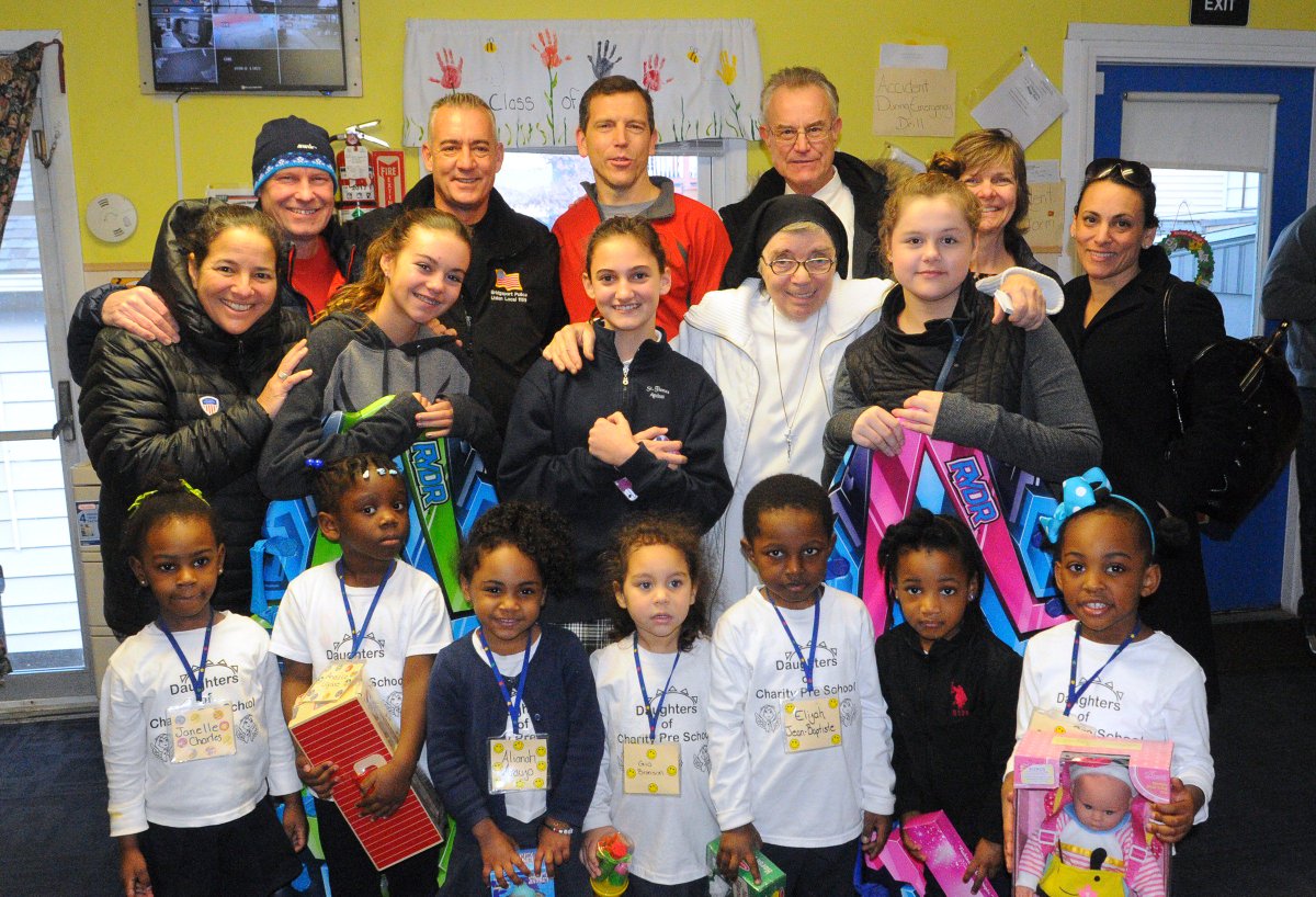 Members of BRYC and their kids deliver donated toys to Sister Theresa at the Daughters of Charity in Bridgeport.