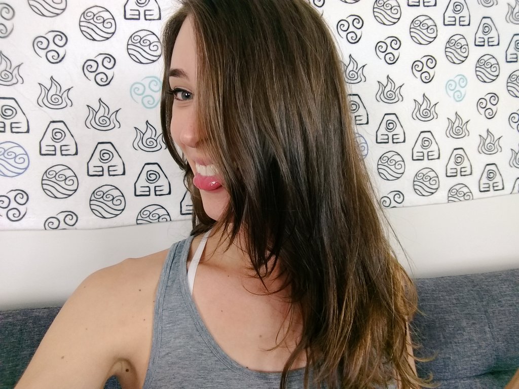 Riley looking to left, sticking her tongue out, with her hair covering her face