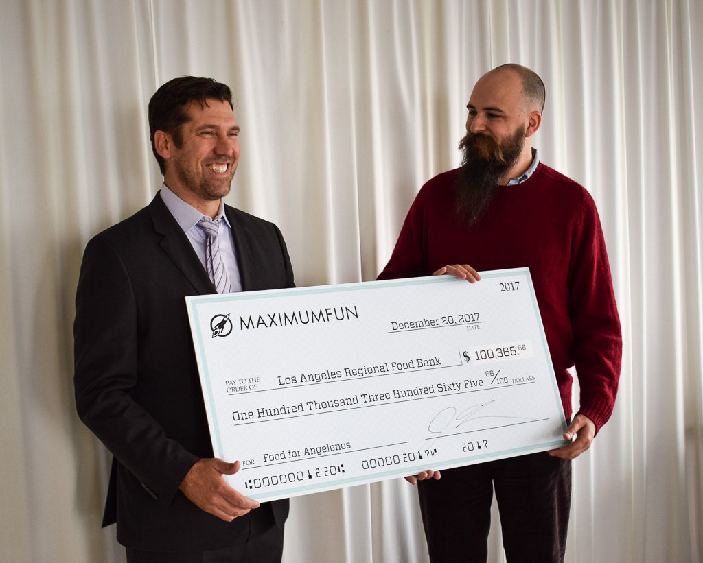 MaxFunHQ's tweet photo. We are absolutely thrilled to share some very happy news with you: Yesterday, our friends from the @LAFoodBank dropped by MaxFun HQ so @jessethorn could present them with a giant novelty check for the amount we raised during pin sale. More details: https://t.co/CPorpgf6pq https://t.co/FRm0DGEbOS