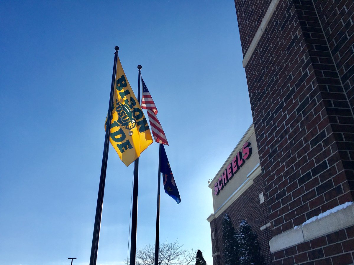 NDSUathletics's tweet photo. Proud to see the #BisonPride flag flying outside @SCHEELS in Fargo! Also excited to see an awesome selection of @NDSUlicensing Frisco merchandise inside the store!
#ThunderingBack #HerdForTheHolidays
#StopByToday https://t.co/IwKFDrmEXd