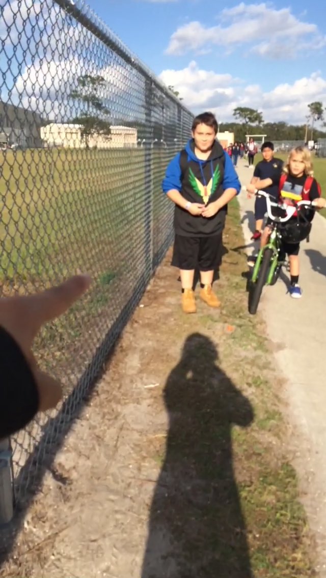 adoringfack's tweet photo. So I was walking out of school and I saw this. The kid has a classic maverick hoodie and the other kid has a red drop back pack @LoganPaul https://t.co/LllWXCvZfc