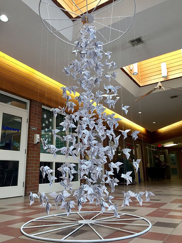 The 2017 Christmas Tree was designed Gr11 Drawing &amp; Painting students. The doves are suspended with thread in the shape of a Christmas tree. We hope the tree evokes feelings of peacefulness with the delicate shapes of doves suspended in space. Merry Christmas.