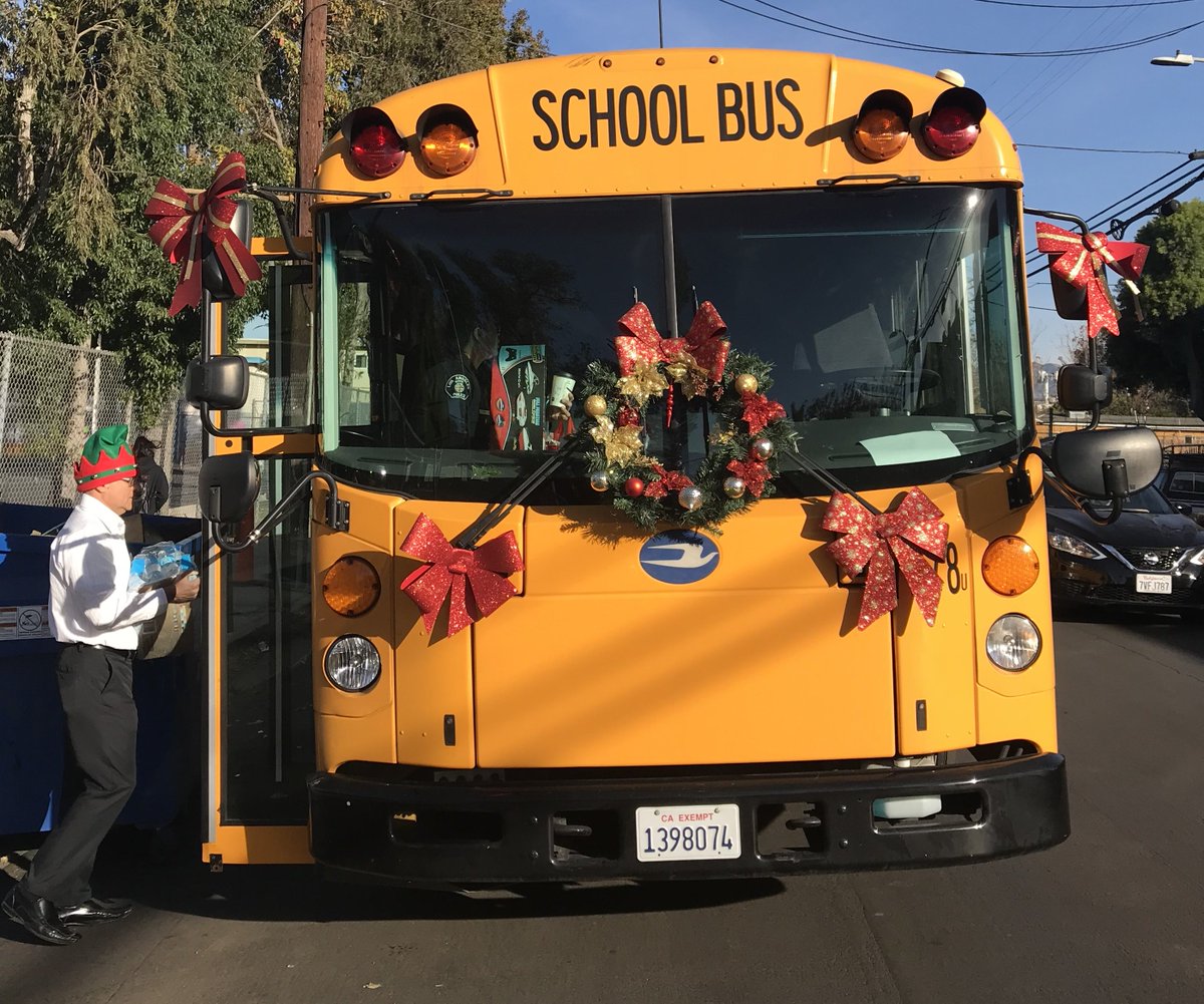 .@LASPD and reps from @KellyGonez and Local District Northwest depart from Langdon ES, taking gifts to 10 local families. We love sharing the holiday spirit with the school community!